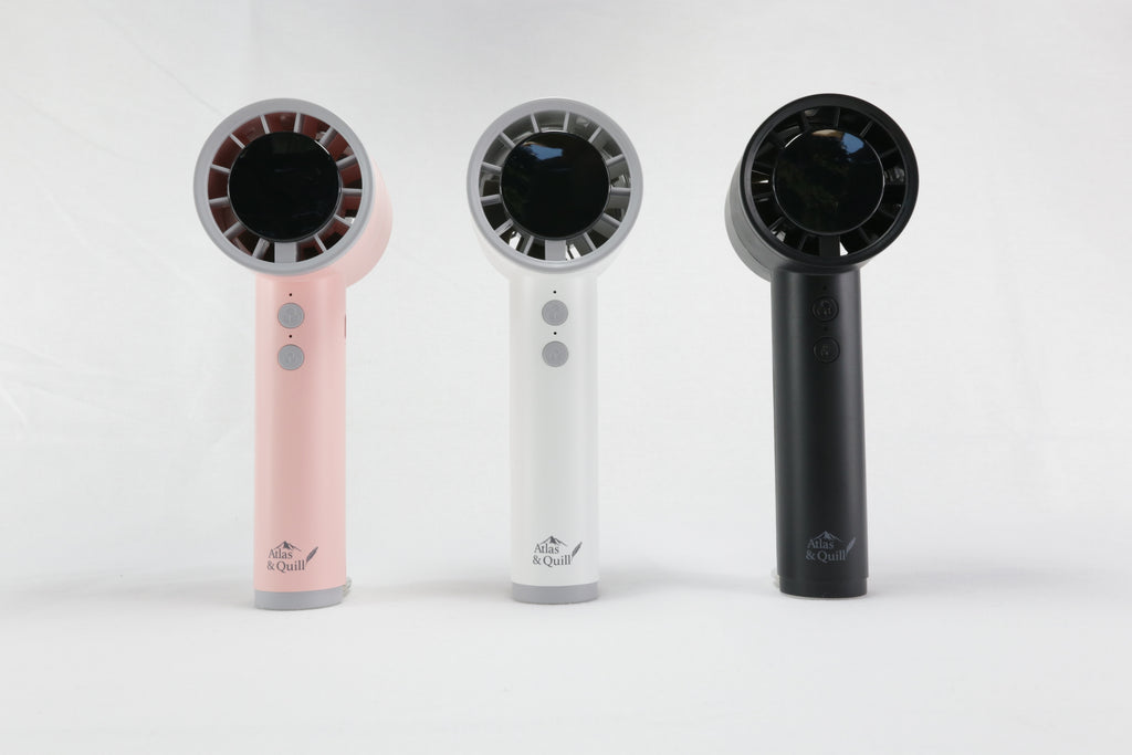 Three handheld hair dryers in pink, white, and black on a white background