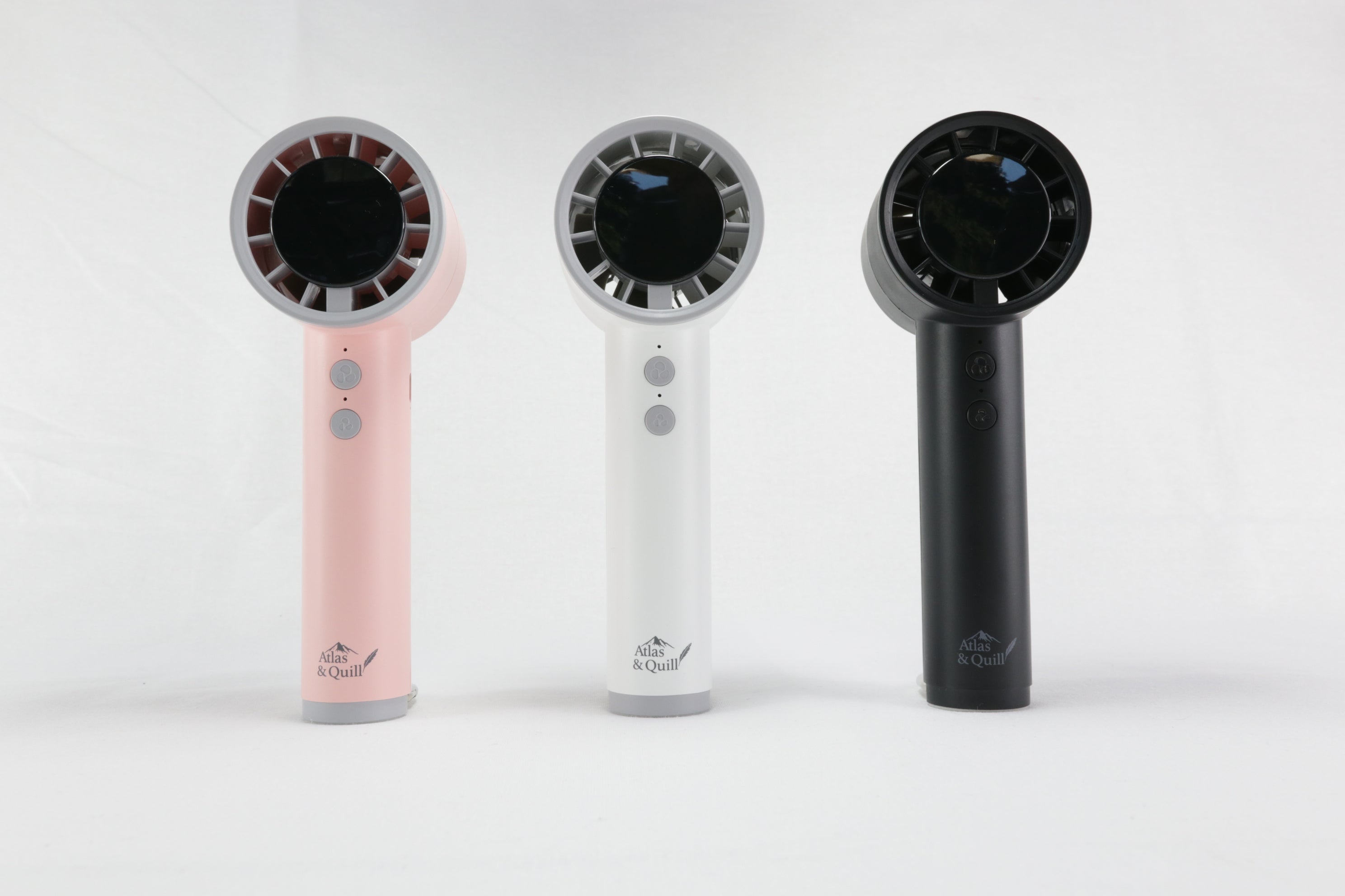 Three handheld hair dryers in pink, white, and black on a white background