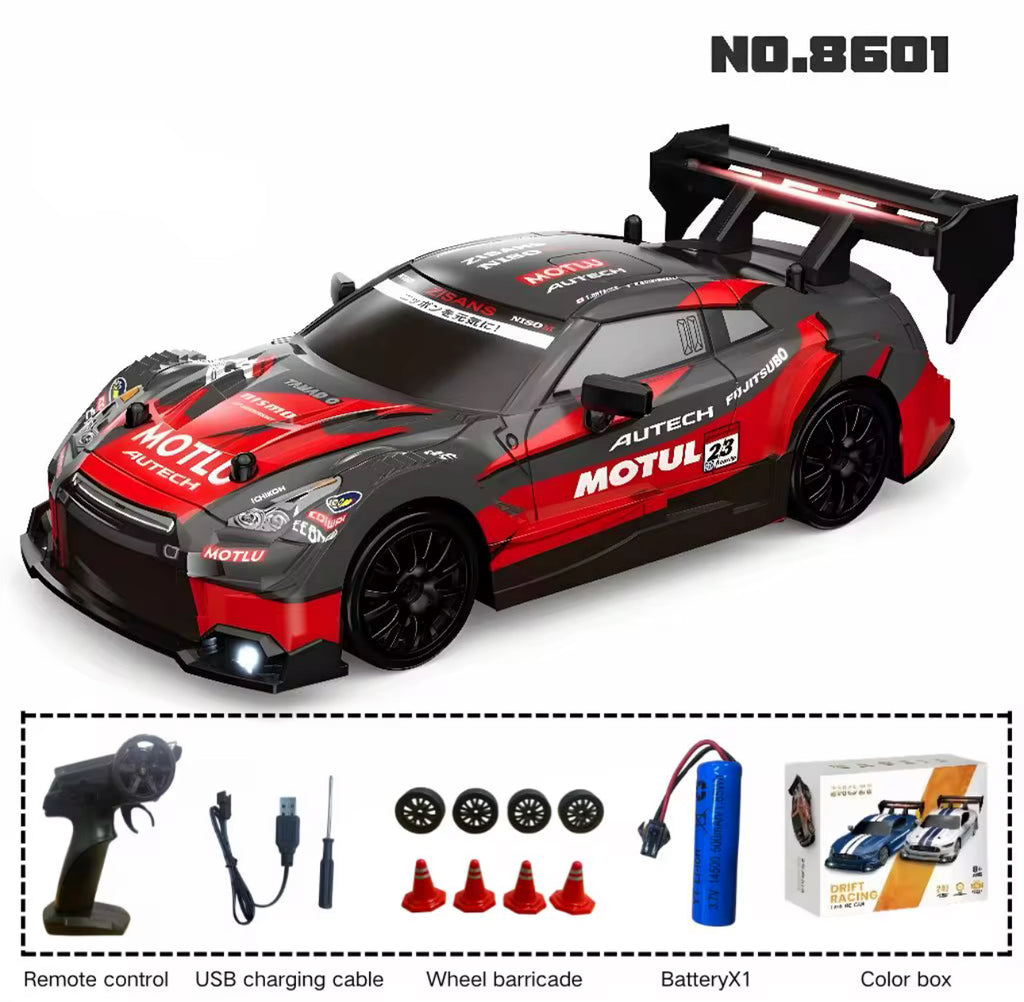 Red and black toy race car with accessories on a white background